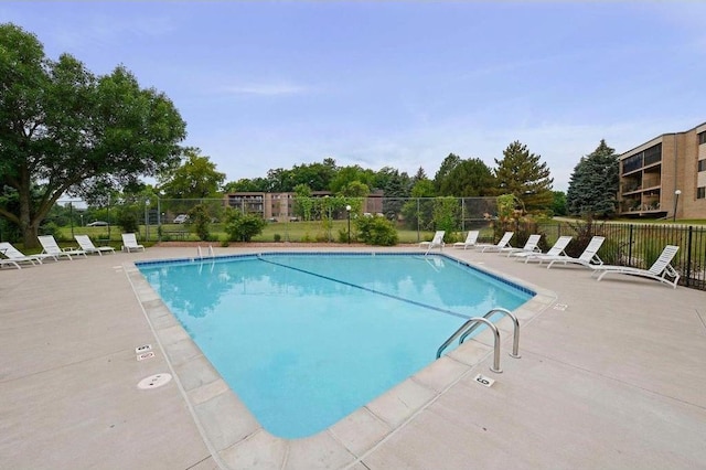 community pool featuring a patio area and fence