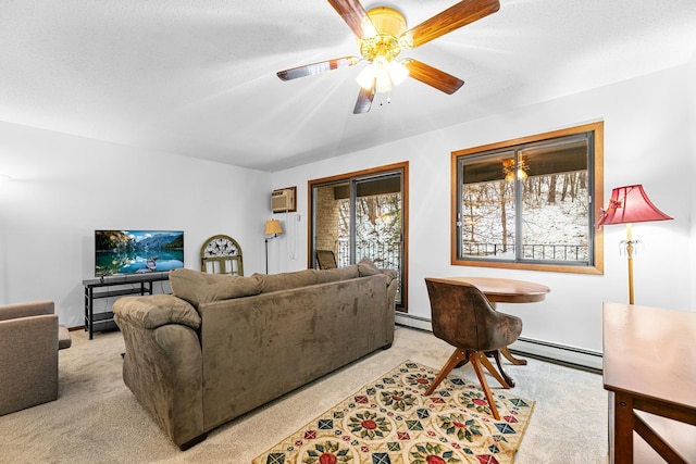 carpeted living area featuring a baseboard radiator, a ceiling fan, baseboards, and a wall mounted air conditioner