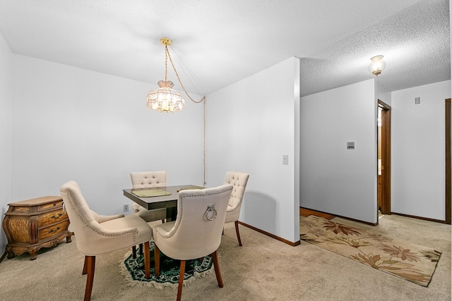 dining area featuring a notable chandelier, carpet, and baseboards