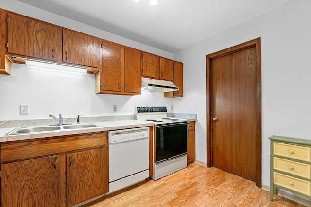 kitchen with white dishwasher, range with electric cooktop, a sink, light wood-type flooring, and under cabinet range hood