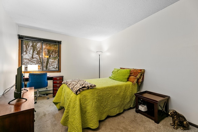 carpeted bedroom featuring a baseboard heating unit and a textured ceiling