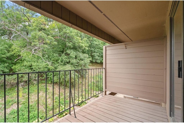 wooden terrace featuring a forest view