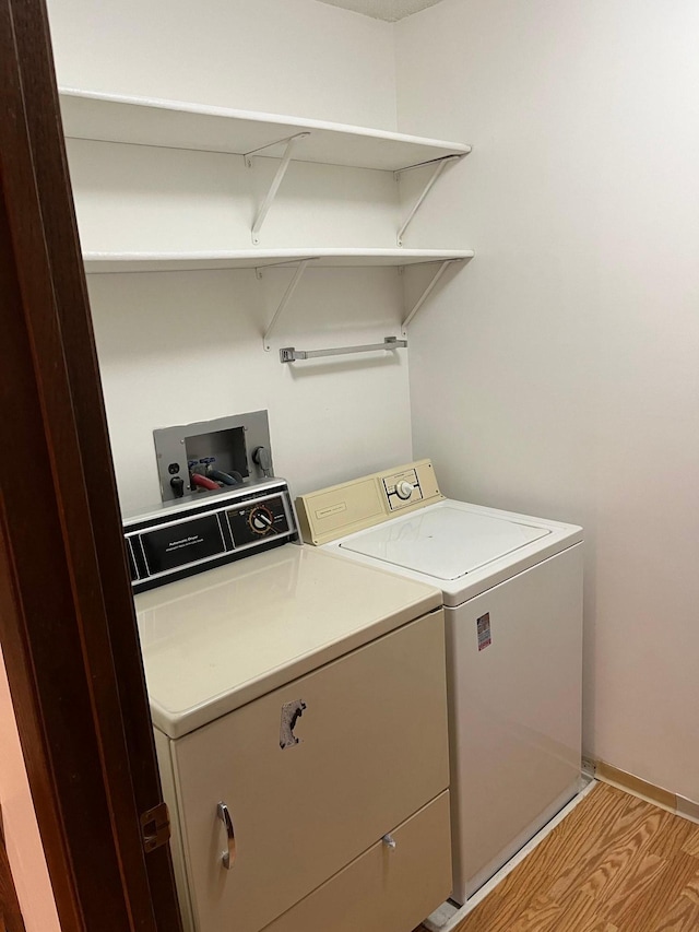 washroom with independent washer and dryer, laundry area, and baseboards