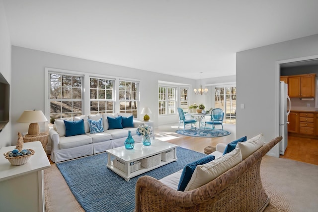 living area featuring an inviting chandelier and light wood finished floors