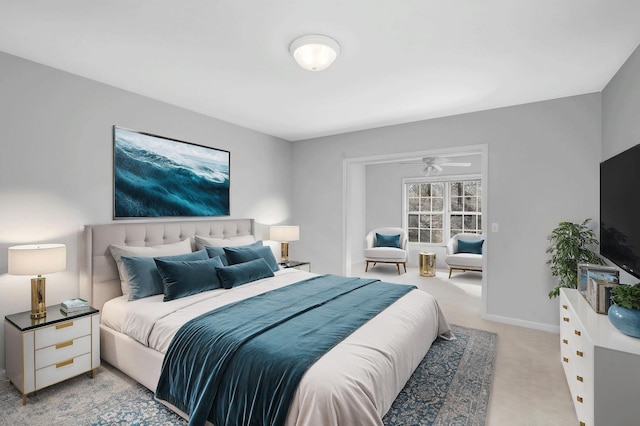 bedroom with baseboards and light carpet