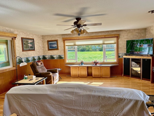 16335 County Road 2, Brainerd, MN 56401 - bedroom with light wood-style flooring, multiple windows, a wainscoted wall, and wood walls