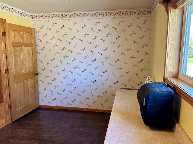 16335 County Road 2, Brainerd, MN 56401 - unfurnished bedroom with wallpapered walls, wood finished floors, and baseboards