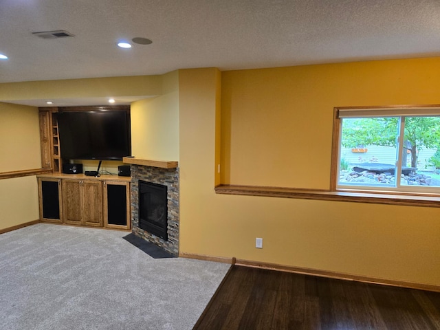 6380 Highland Hills Blvd S, Cottage Grove, MN 55016 - unfurnished living room featuring baseboards, a textured ceiling, a stone fireplace, recessed lighting, and light wood finished floors