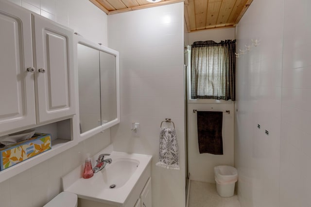 5591 Wildwood Ave, Isle, MN 56342 - bathroom featuring tile walls, vanity, and wood ceiling