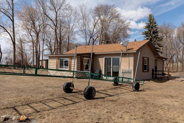 5591 Wildwood Ave, Isle, MN 56342 - back of property with stucco siding and a shingled roof