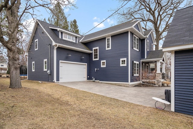 5234 Grand Ave, White Bear Twp, MN 55110 - rear view of house featuring a trampoline, driveway, a shingled roof, and a yard