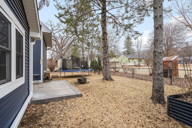 5234 Grand Ave, White Bear Twp, MN 55110 - view of yard featuring a trampoline, a fenced backyard, and a patio