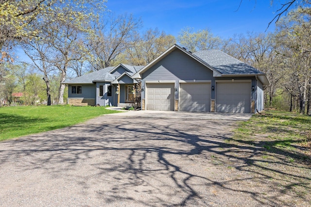 ranch-style home featuring asphalt driveway, a garage, roof with shingles, and a front yard