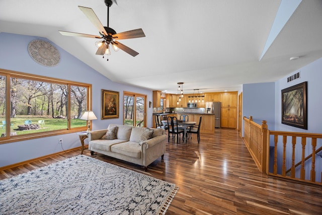 living room with dark wood finished floors, vaulted ceiling, ceiling fan, and baseboards