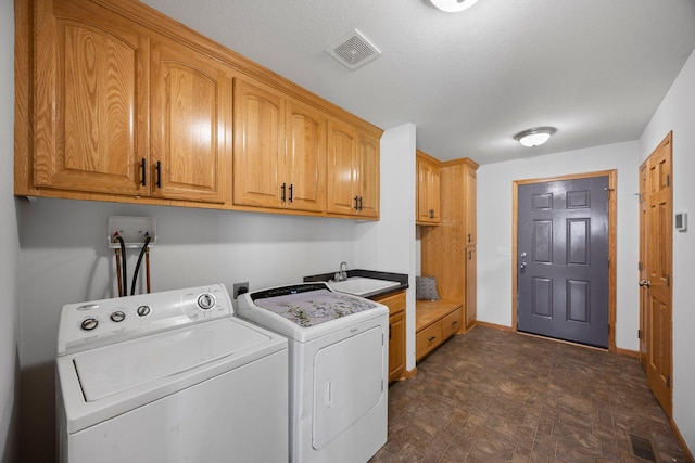 clothes washing area with cabinet space, washer and clothes dryer, baseboards, and stone finish flooring