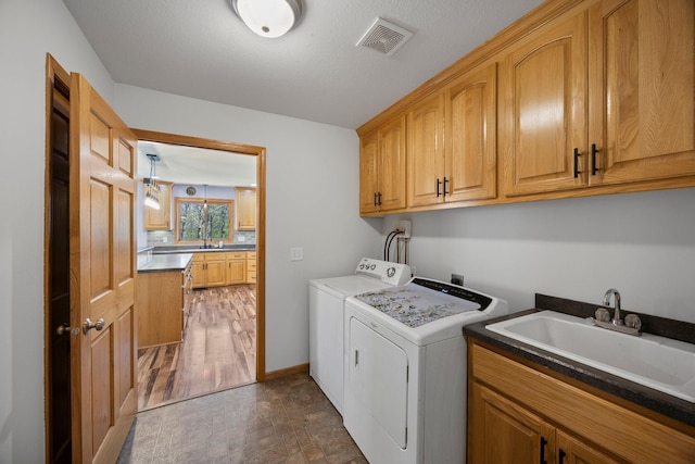 washroom featuring washer and clothes dryer and cabinet space