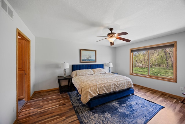bedroom with wood finished floors, baseboards, and a ceiling fan