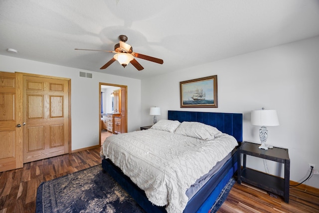 bedroom with wood finished floors, baseboards, ceiling fan, and ensuite bathroom