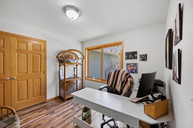 office space featuring wood finished floors and baseboards