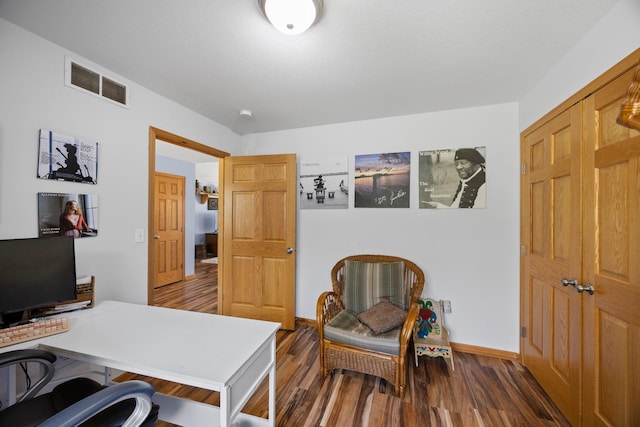 office space featuring dark wood-style flooring and baseboards
