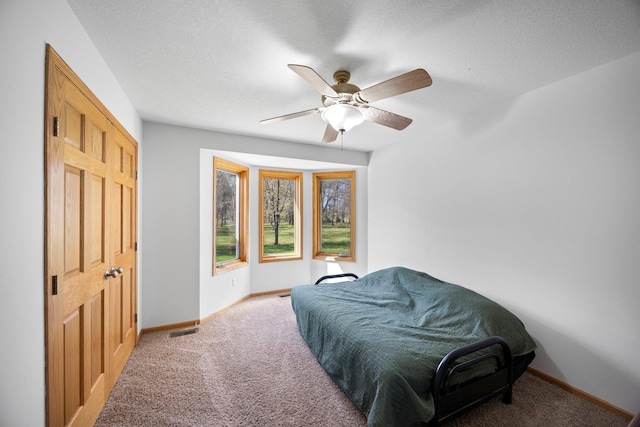bedroom with carpet, baseboards, and a ceiling fan