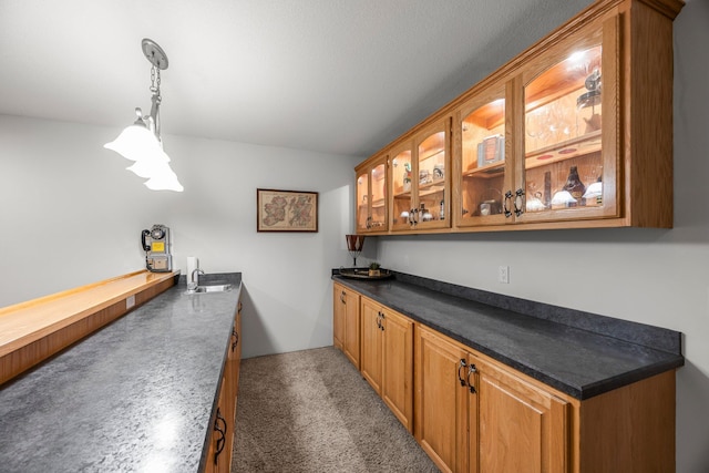 bar area featuring decorative light fixtures and a sink