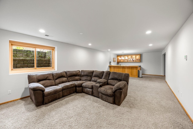 living area featuring a bar, light colored carpet, recessed lighting, and baseboards