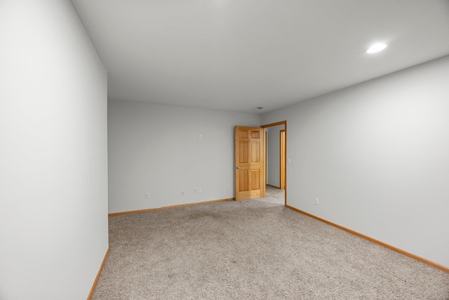 empty room with baseboards, light carpet, and recessed lighting