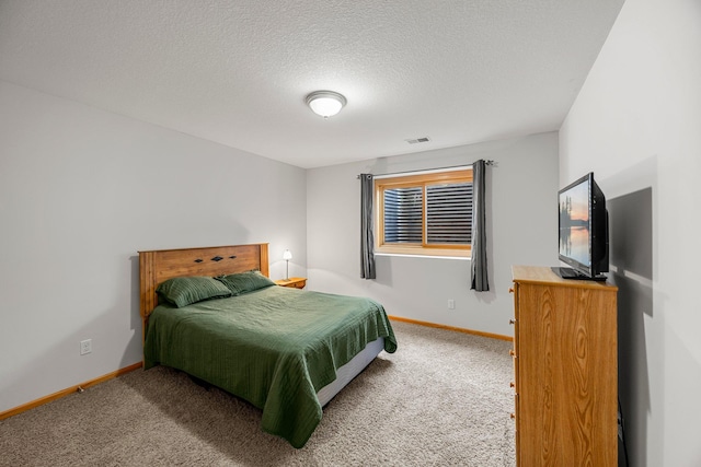 carpeted bedroom featuring baseboards and a textured ceiling