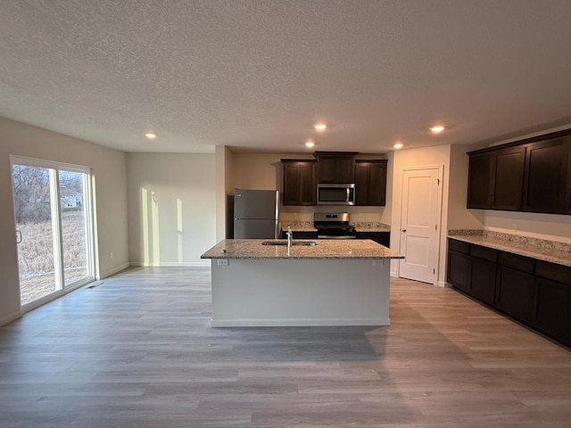 521 Douglas Dr S, Annandale, MN 55302 - kitchen with appliances with stainless steel finishes, recessed lighting, light stone countertops, light wood-style floors, and a textured ceiling