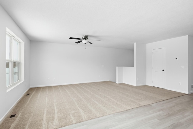 521 Douglas Dr S, Annandale, MN 55302 - unfurnished living room with a ceiling fan and light wood-type flooring