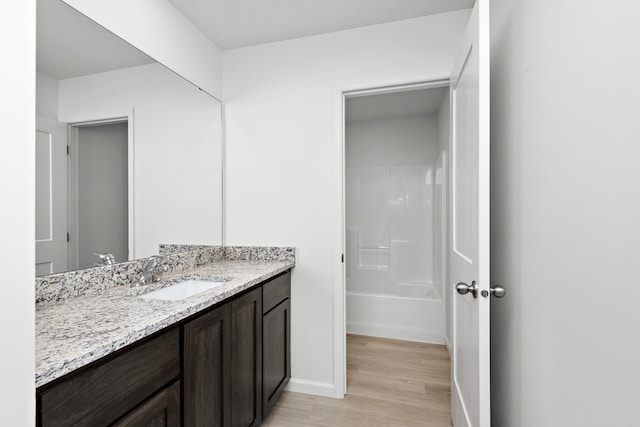 521 Douglas Dr S, Annandale, MN 55302 - bathroom with vanity, wood finished floors, and bathtub / shower combination