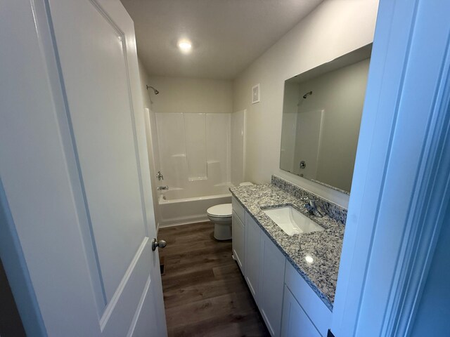 full bathroom featuring vanity, toilet, visible vents, bathtub / shower combination, and wood finished floors