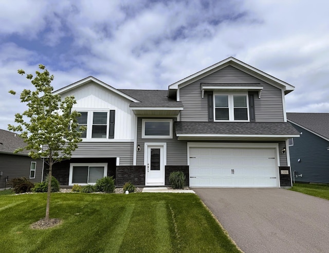 520 Valley Dr W, Annandale, MN 55302 - view of front facade featuring asphalt driveway, a garage, a front lawn, stone siding, and a shingled roof
