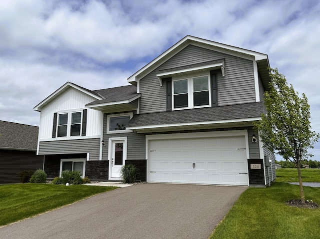 520 Valley Dr W, Annandale, MN 55302 - view of front of home with roof with shingles, an attached garage, driveway, a front yard, and stone siding