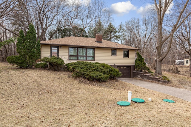 single story home with roof with shingles, aphalt driveway, an attached garage, and a chimney