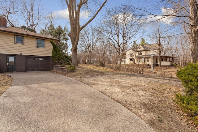 view of property exterior with driveway and a garage