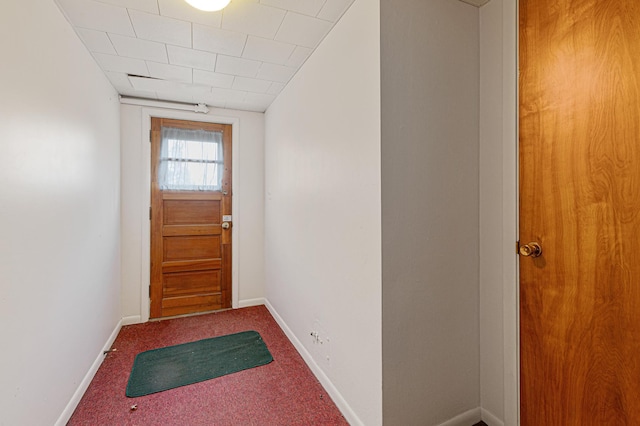 doorway to outside with carpet and baseboards