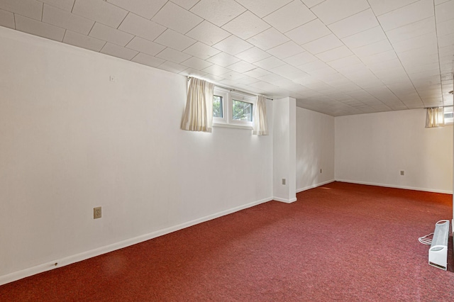 basement featuring baseboards and carpet
