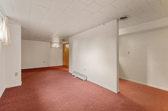 basement with baseboards, visible vents, and carpet