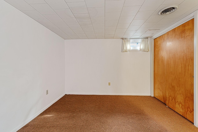 basement featuring carpet, baseboards, and visible vents