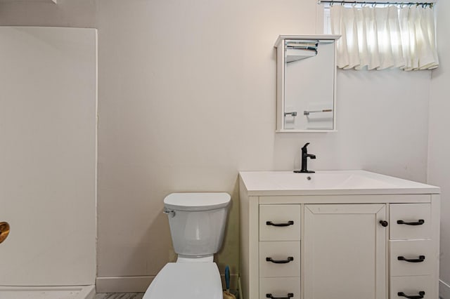 bathroom with toilet and vanity