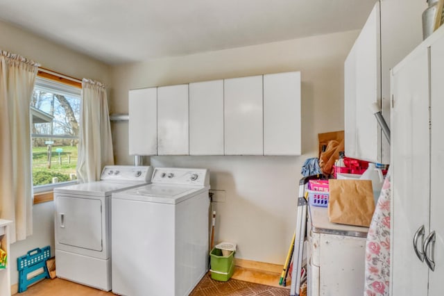laundry area with cabinet space, baseboards, and washing machine and dryer