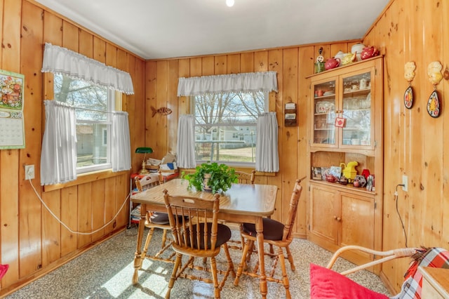 dining space with wood walls