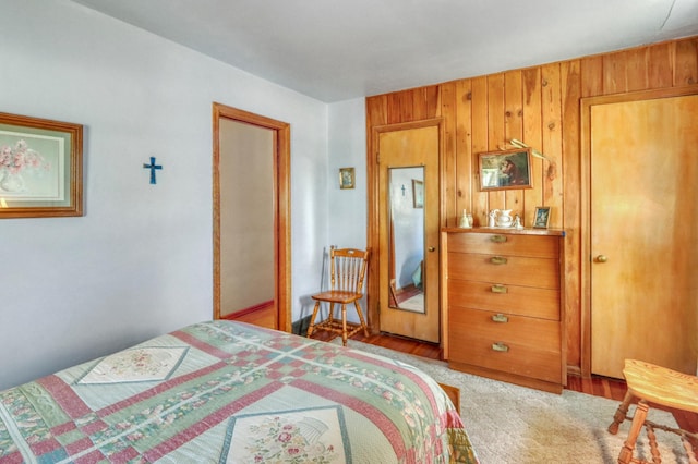 bedroom with wood walls