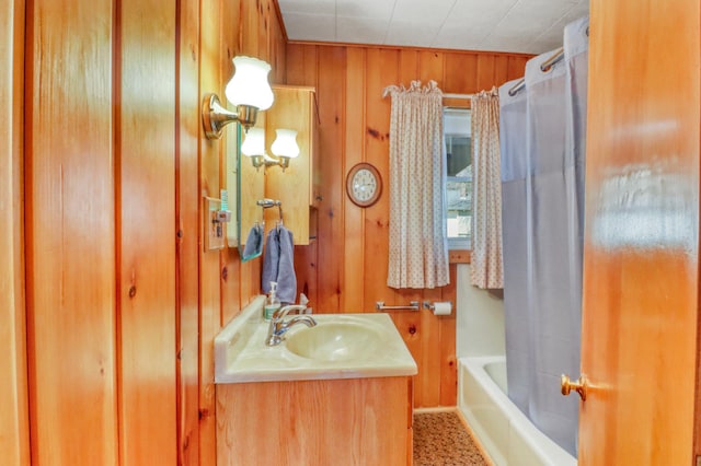 bathroom featuring vanity and wood walls