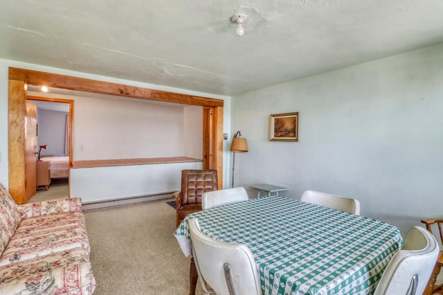 carpeted dining area featuring a baseboard radiator
