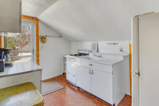 interior space with baseboards and a sink