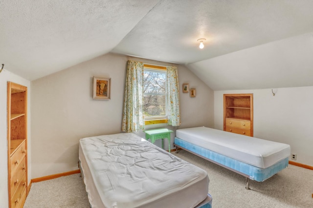 carpeted bedroom with baseboards, vaulted ceiling, and a textured ceiling