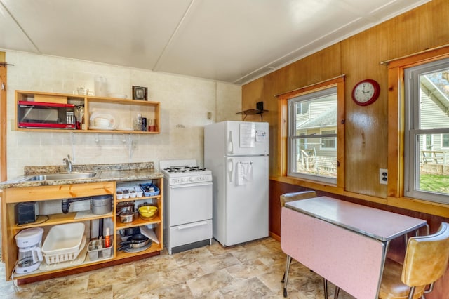 kitchen featuring plenty of natural light, a sink, open shelves, and white appliances